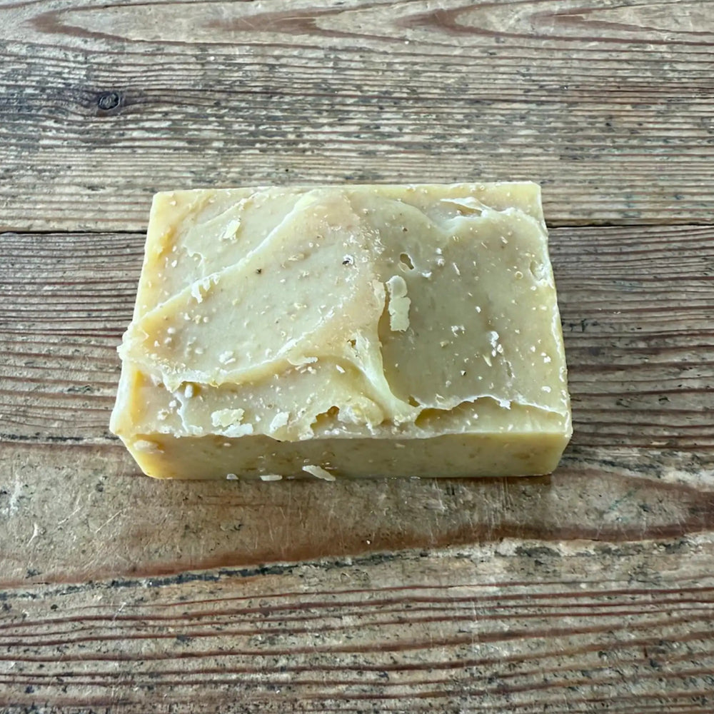 Bar of natural puppy soap shampoo bar on a wooden surface.